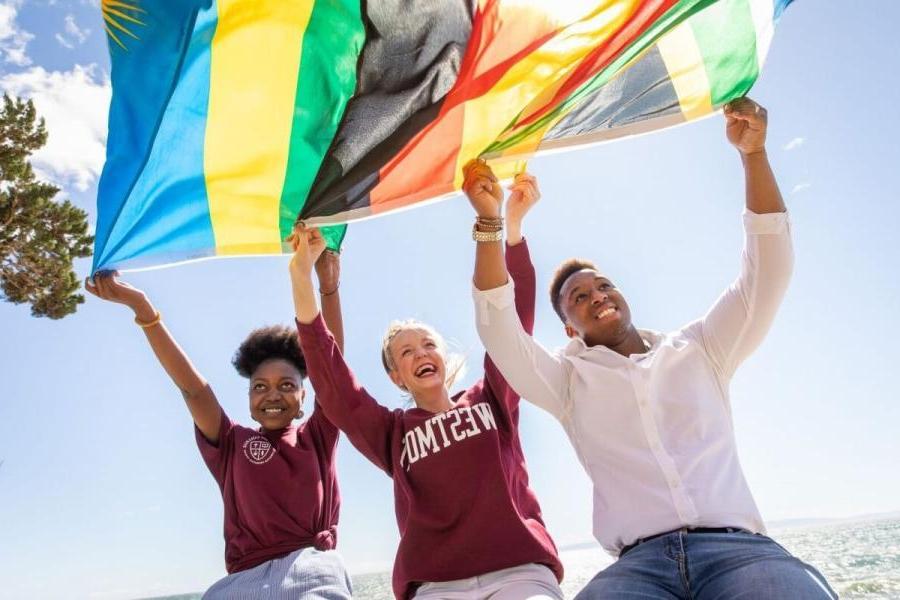 international students holding up flag